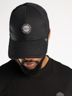 Evolve Black Polyester Trucker Cap.AOP And Rubber Badge.